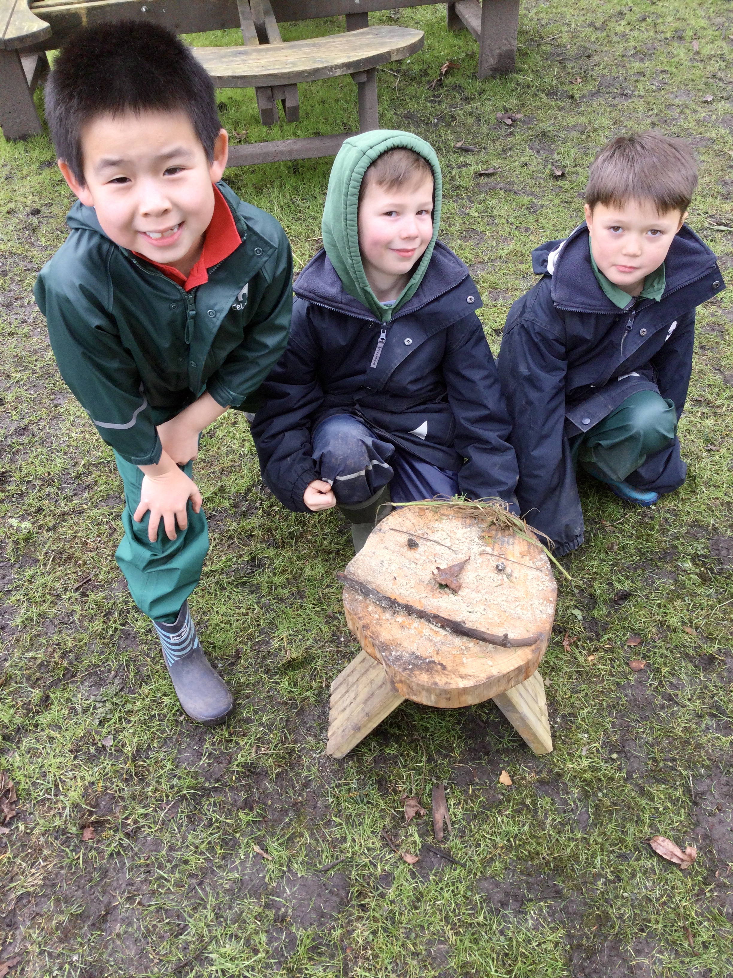 boys creating a wooden face