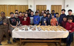 Group of boarders displaying their baking results